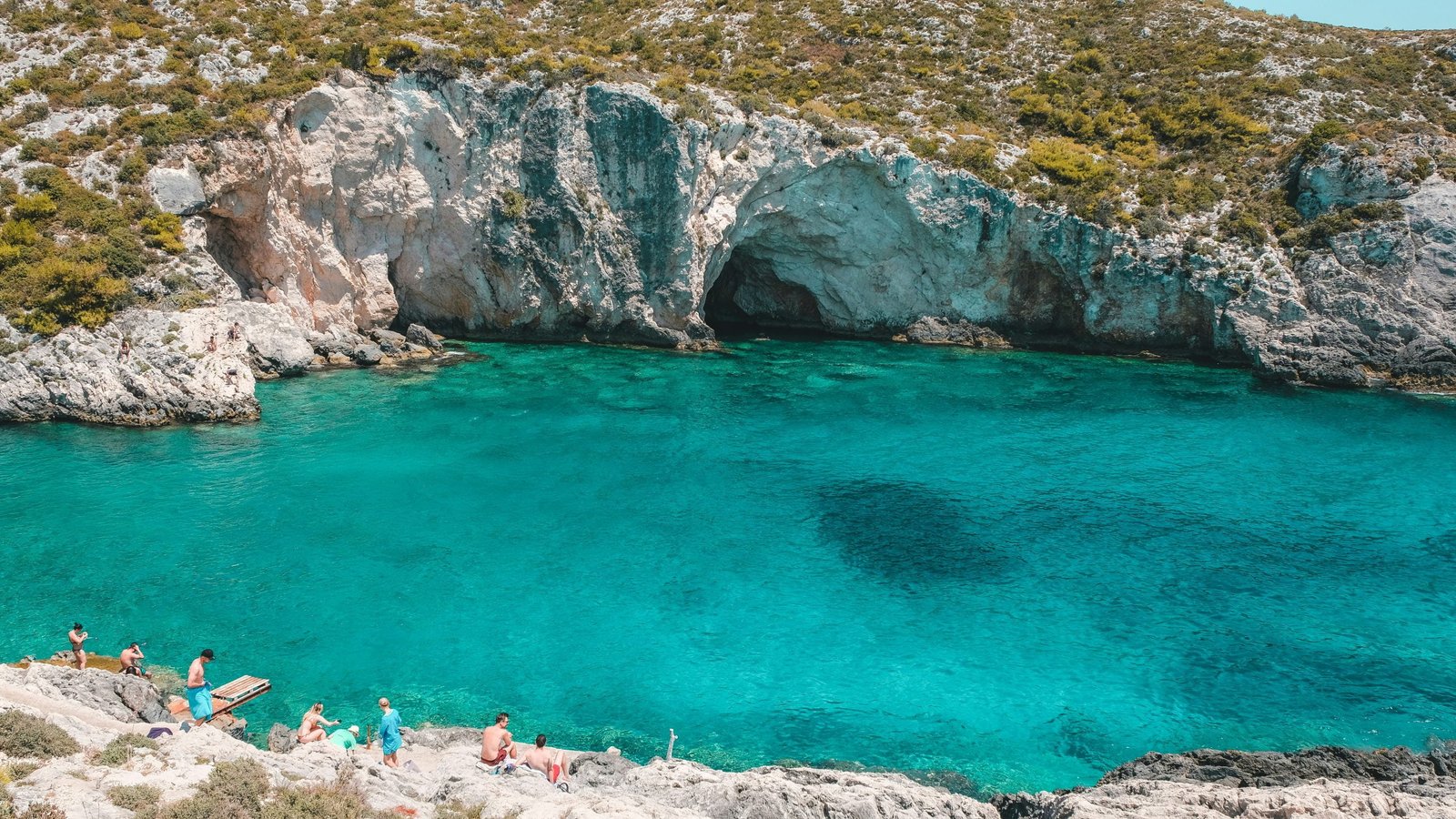 people swimming on beach during daytime